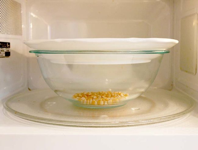 Cook popcorn in the microwave with a bowl and a plate, no unhealthy chemicals needed!