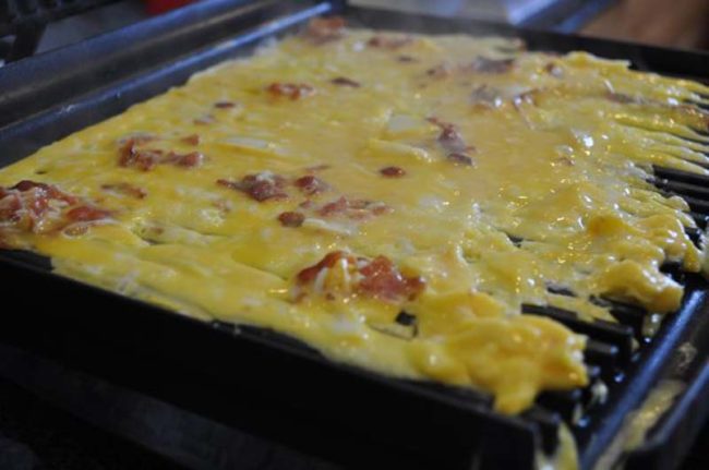 You can use a George Foreman grill or panini press to make omelettes, hassle-free.