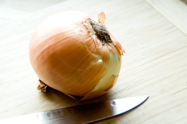 Cut the end off your onion and soak the rest in cold water for 30 seconds to stop from crying.