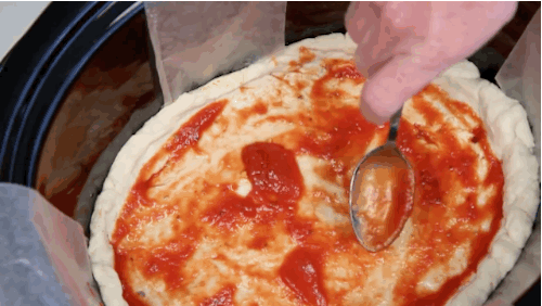 Spread tomato sauce on the top of the dough.