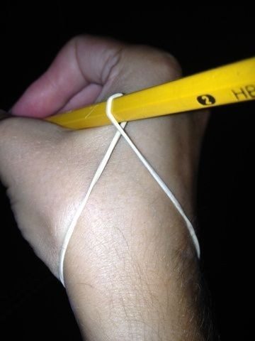 Use a rubber band to teach your kids how to hold a pencil and write properly.