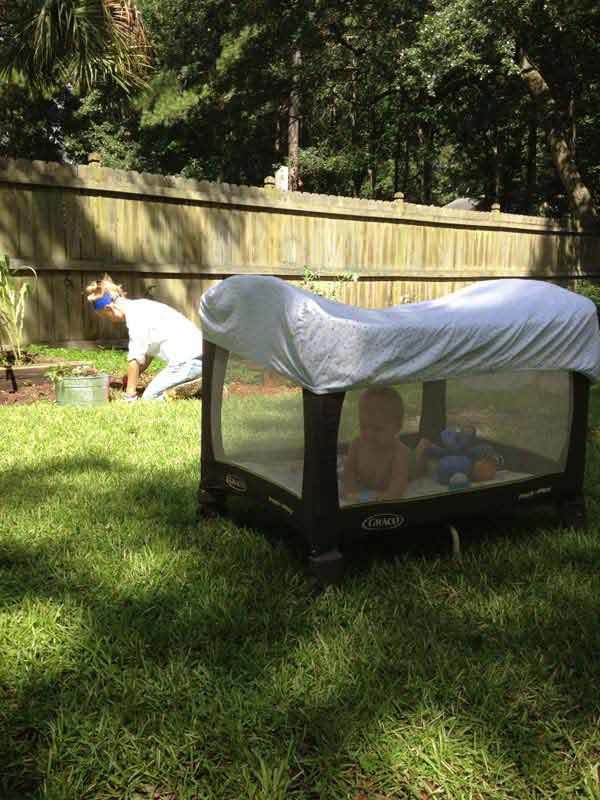 Give your baby some shade and shield them from nasty bug bites by putting a crib sheet over their outdoor playpen.