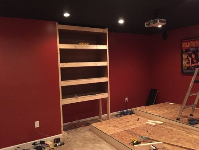 This shelving unit would hold his gaming consoles, video games, and other odds and ends.