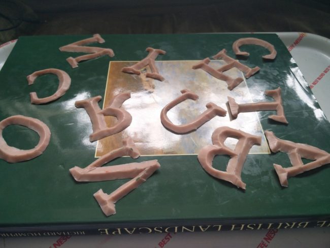 Using them, he traced and cut out each letter. The bevelling was done by hand using an X-Acto knife.