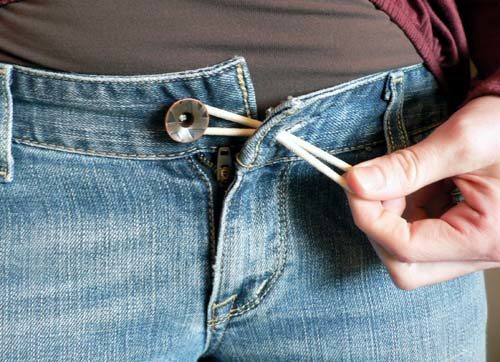 Use a rubber band to extend pants that are too tight.