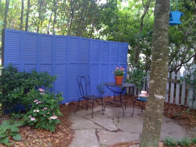 Opt for a more modern fence idea with recycled shutters.