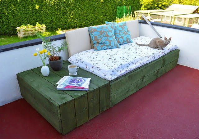 Throw an old mattress on a stack of pallets and you've got a beautiful couch and side table.