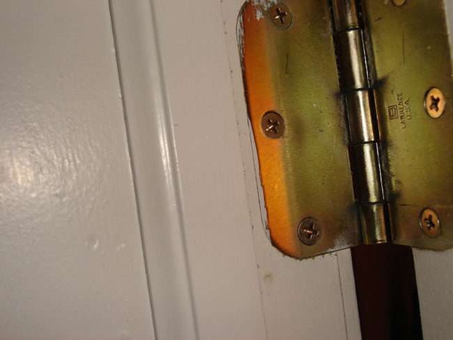 Fix a squeaky door by applying some Vaseline to the hinges.