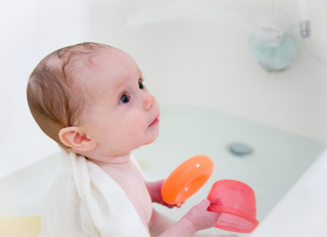 Rub some Vaseline in your baby's brows to stop soapy suds from going into their eyes. It will reroute most of the water.