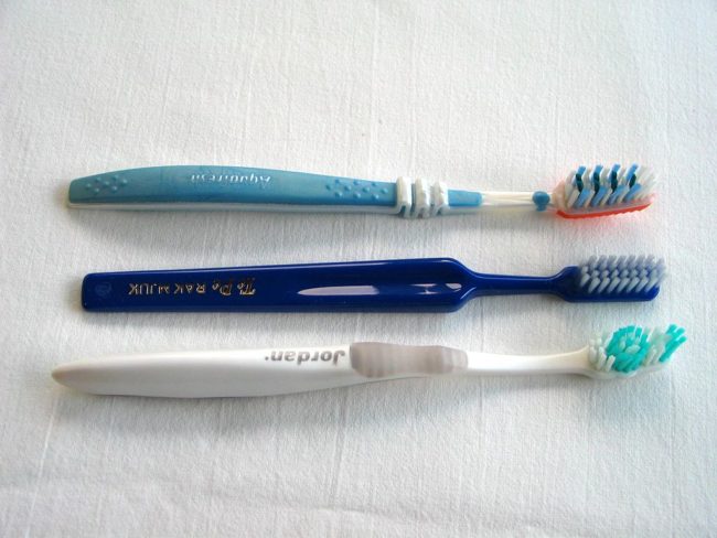 Soak your toothbrushes in white vinegar as a natural way to clean them.