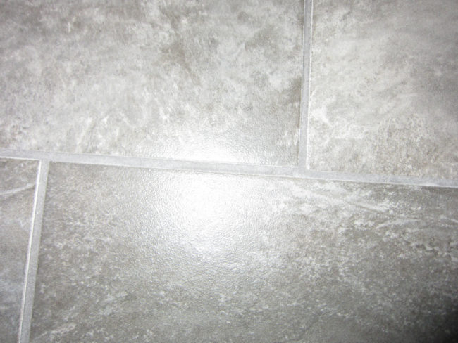 A simple mixture of three parts baking soda to one part bleach can be used to scrub your bathroom tile's grout.