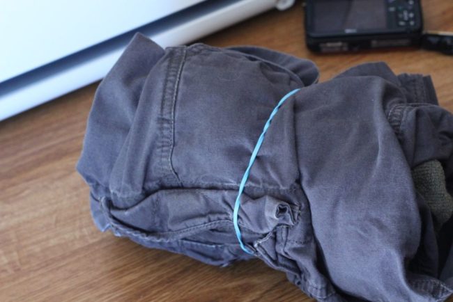 Wrap your clothes with rubber bands to keep them secure and neat on a camping or backpacking trip.