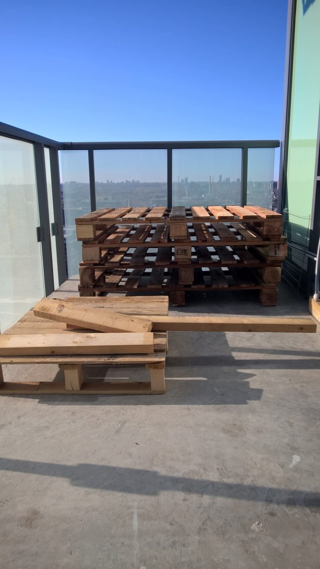 After he collected wood pallets from around the neighborhood, he brought them up to his balcony.