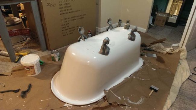 They cleaned the tub's feet, primed them, painted them, and attached them to the tub.