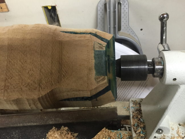 He mounted the wood on his lathe and started rounding the corners.