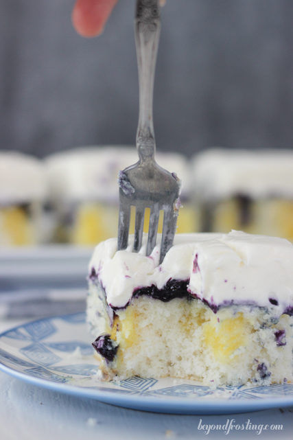 This bad boy has <a href="http://beyondfrosting.com/2015/07/09/blueberry-cheesecake-poke-cake/" target="_blank">cheesecake pudding and blueberry sauce</a> in it.