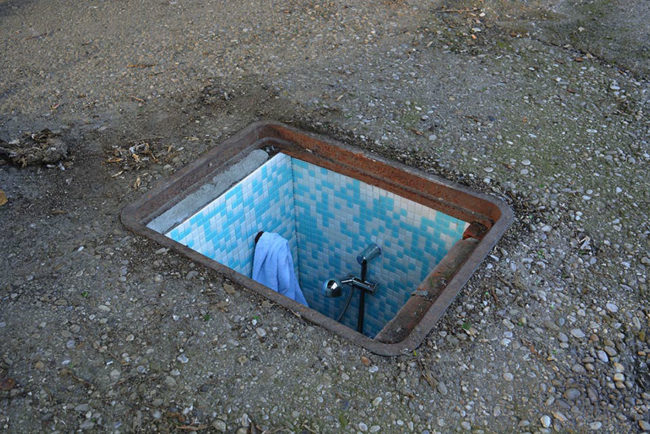 By creating three rooms hidden under manholes in Milan's Lodi district, the artist aimed to bring attention to the fact that hundreds of underprivileged people in Bucharest, Romania, call the sewage system home.