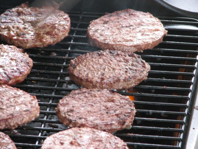 Make a shallow well in the middle of all those patties with your thumb and place them on the grill. Put a small ice cube in each well to help the burgers retain their shape and keep them nice and juicy.