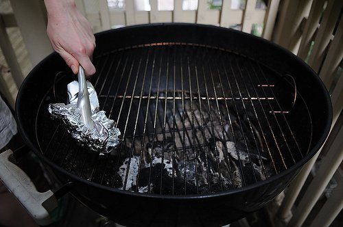 Cover your grill with tinfoil, warm it up, crumple the foil, and use it to scrub off stubborn messes.
