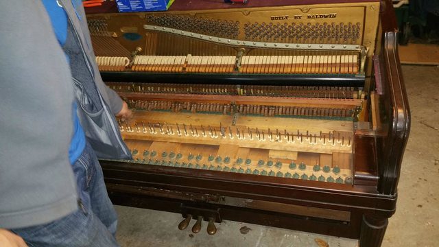 First, he had to gut the piano to create storage space.