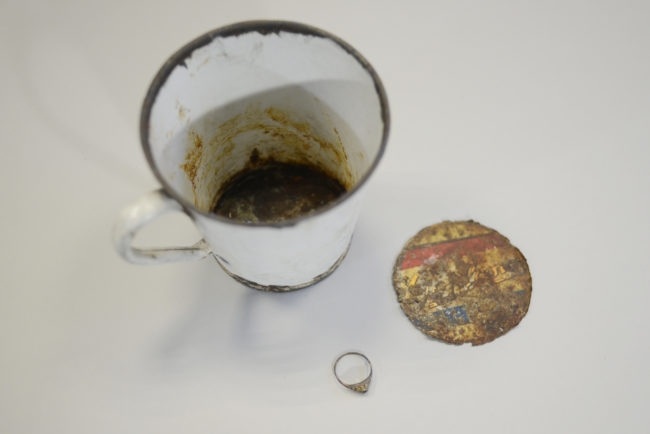 Inside of this mug, researchers found a ring and a necklace. They were once covered by a false bottom, but years of decay revealed the truth.