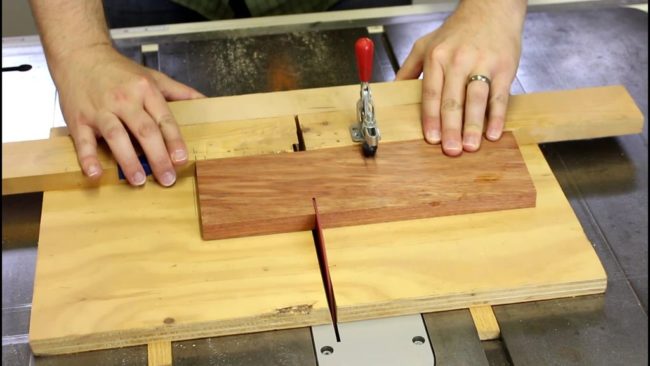 Using a table saw, Brown cut a piece of bloodwood into the same size.