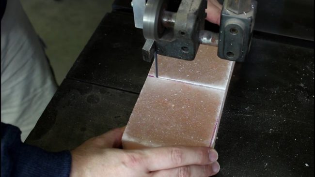 First, he cut the huge slab into two four-inch squares using a bandsaw.