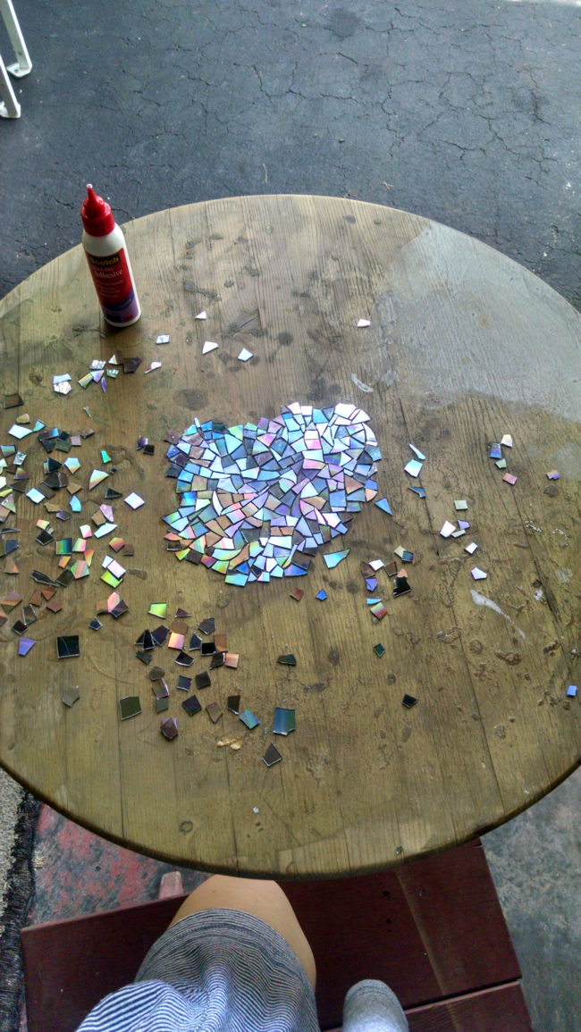 She used a quick-dry adhesive and began gluing the shards to the table, starting in the center and working her way out.