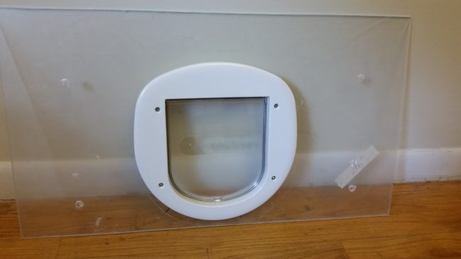 <a href="https://www.reddit.com/user/Boysterload/" target="_blank">Boysterload</a> cut a hole in his Plexiglass with a jigsaw and used a cat door he bought at a pet store for the entrance.