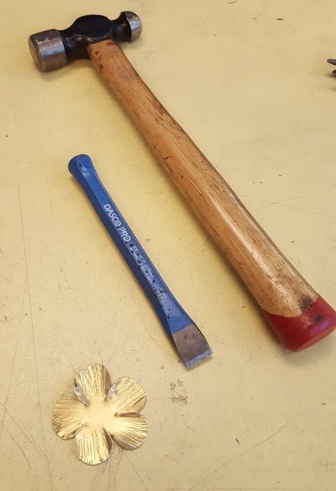 A hammer and chisel were used to add some texture to the petals.