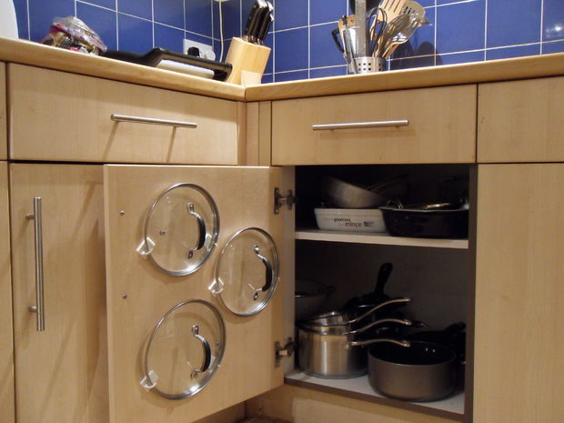 Keep pot lids orderly by mounting them via hooks on your cupboard doors.