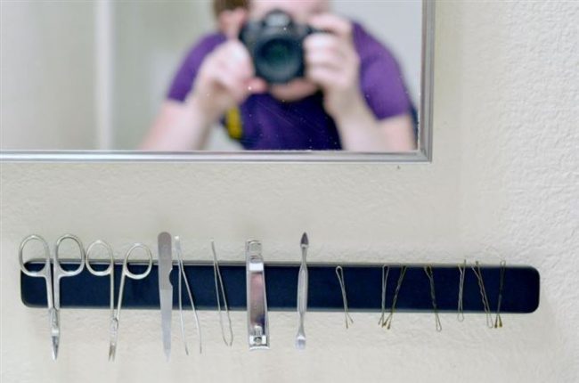 Keep all those tiny bathroom tools in one place by mounting a magnet on your wall.