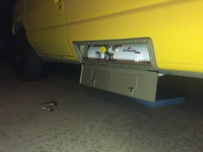 After he cut a hole out of the van's side, he placed a propane tank inside and sealed it up with a hinged door.