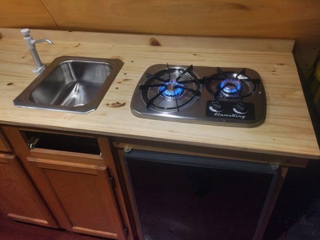 A sink, burner, and refrigerator were also installed.