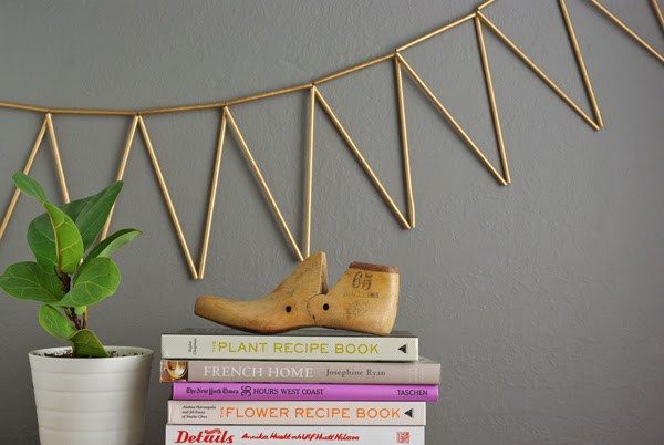 <a href="http://oleanderandpalm.com/2014/03/golden-straw-bunting.html" target="_blank">Make party decorations</a> with gold spray paint and straws that are way cuter (and way cheaper) than anything you'd find at the craft store.