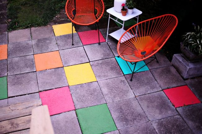 <a href="http://www.abeautifulmess.com/2013/07/elsies-painted-patio-tiles-.html" target="_blank">Add some flare</a> to your patio with latex paint.