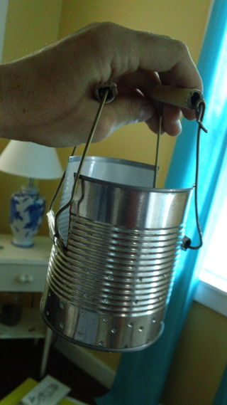 Finally, put the handles you created around the flaps. You now have ourself a tin can stove!