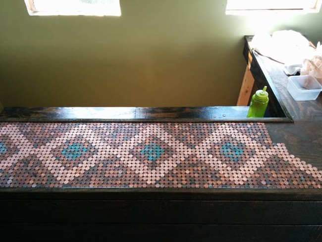 This geometric mosaic is made with pennies of all different coppery colors.