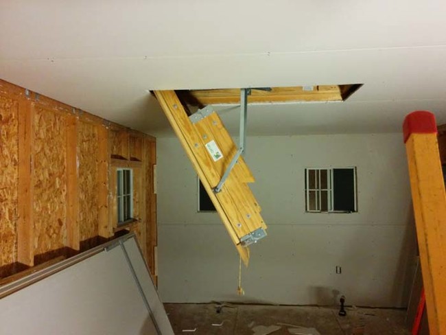When he was adding the drywall to the ceiling, he also installed a pull-down ladder for the attic space.