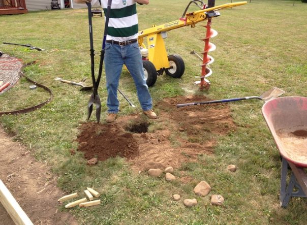 With some help from his father-in-law, he dug holes that'd eventually hold support beams.