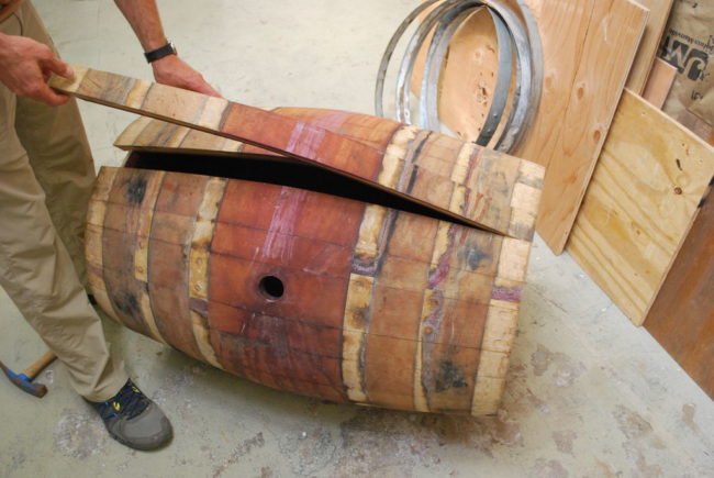 Once they're off, the barrel's staves -- or wooden slats -- come apart easily.