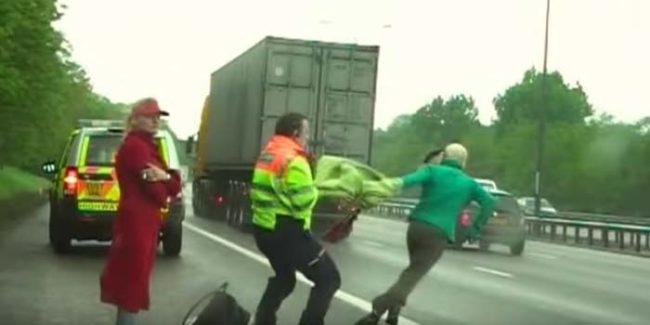 Our story begins with police questioning a pair of women alongside a busy highway. A film crew with the police catches the interaction. Then, right in the middle of talking, one of the women makes a run for it and heads straight into traffic.