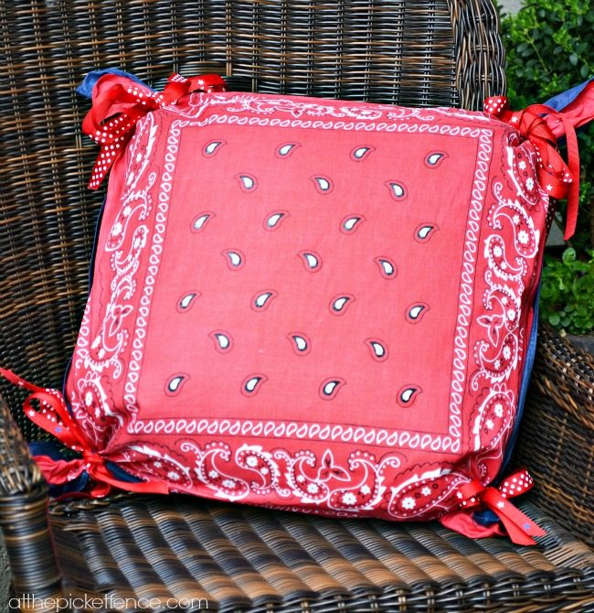 Use the outdoor pillows you already have and give them a <a href="http://www.atthepicketfence.com/2013/06/4th-of-july-front-porch-decor.html" target="_blank">patriotic punch</a> by tying on festive bandanas.