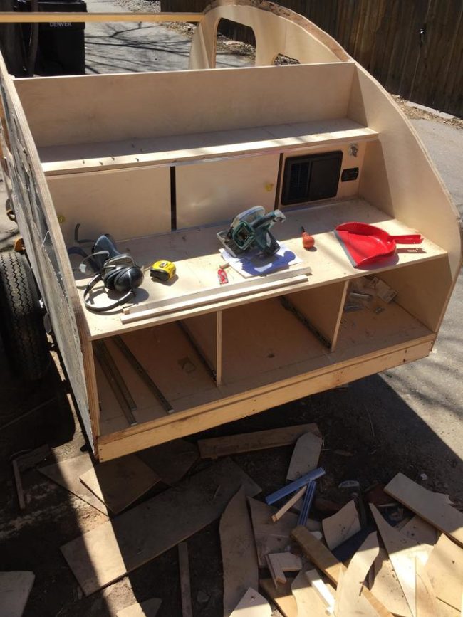 The inside of the trailer had storage but the back of it opened up to a galley kitchen with little cabinets.