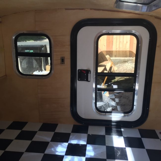 Prefab windows and a door were added along with some checked vinyl for the floor.