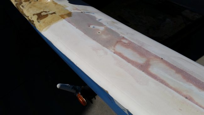 He drilled holes into the fiberglass and then used a syringe to fill them in with exopy resin.