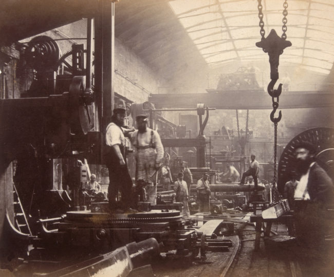 These men are hard at work on building a ship in this London engineering workshop. 