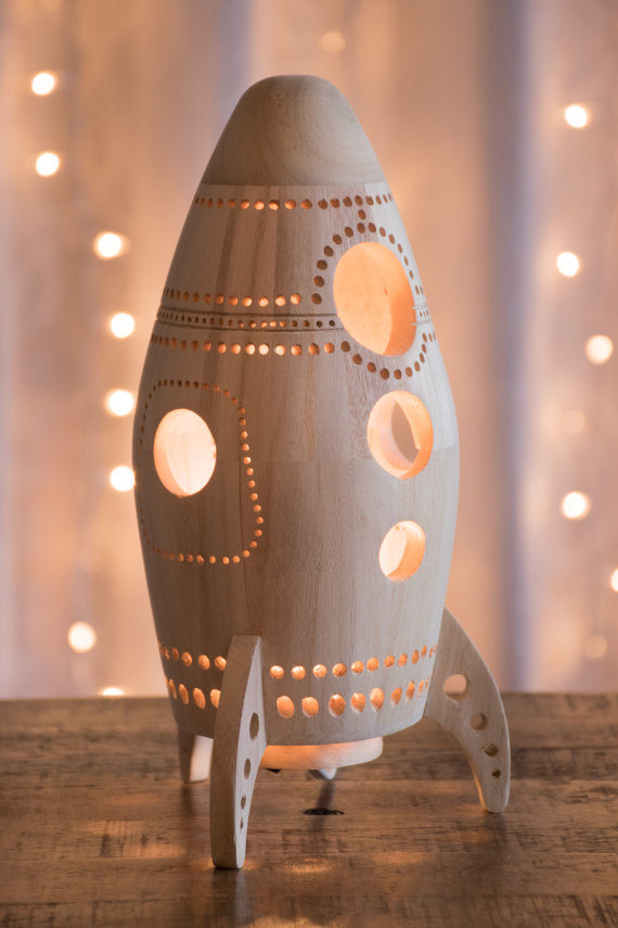 Prepare for nighttime liftoff with this wooden <a href="https://www.etsy.com/listing/262390597/wooden-rocket-ship-night-light-nursery?ga_order=most_relevant&amp;ga_search_type=all&amp;ga_view_type=gallery&amp;ga_search_query=night%20light&amp;ref=sr_gallery_17" target="_blank">rocket ship light.</a>