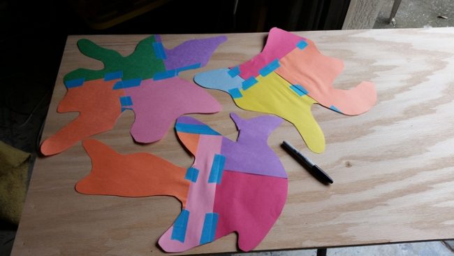 Then, he rearranged the cutouts on plywood.