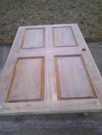 He cut down the door to seat six and then sanded the edges. Treeshugmeback also removed the varnish and stain until only the natural oak showed through.